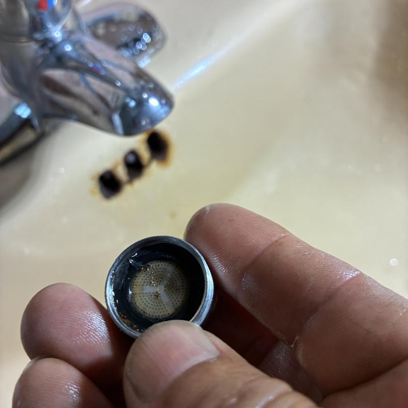 Faucet aerator removal near basin faucet and sink drain