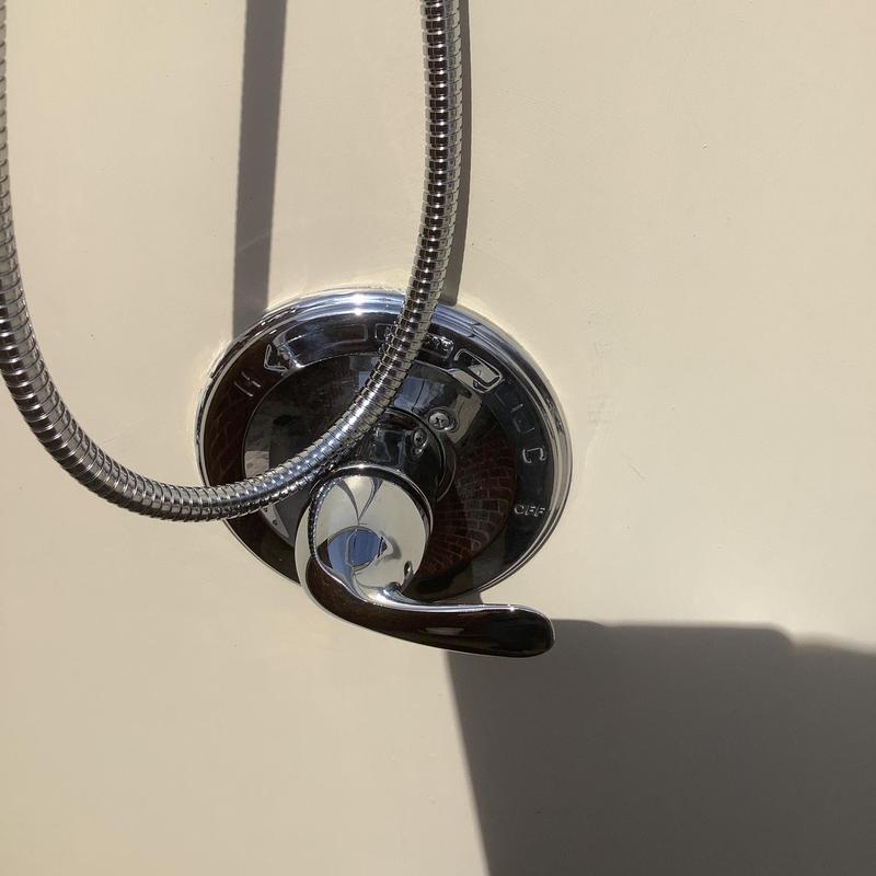 Outdoor shower faucet handle with hose attachment