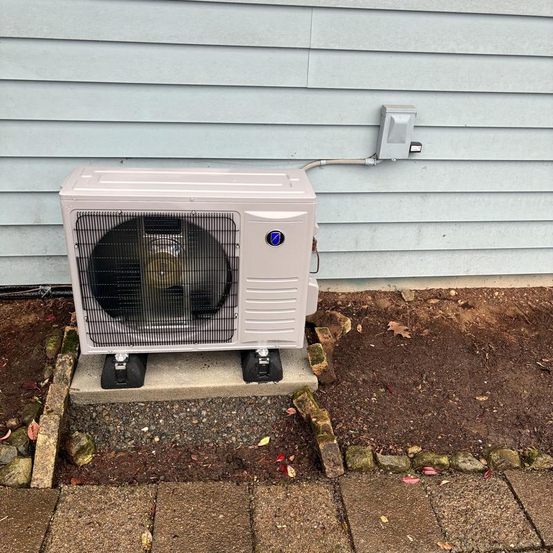 Heat pump outdoor unit installed on concrete pad Heat pump outdoor unit installed on concrete pad