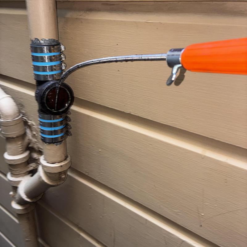 Kitchen drain stack cleaning with plumbing snake