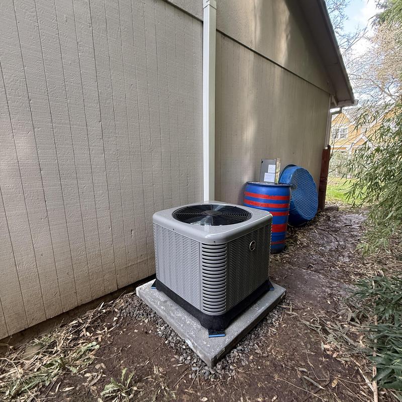 Central air conditioning system unit on concrete pad Central air conditioning system unit on concrete pad