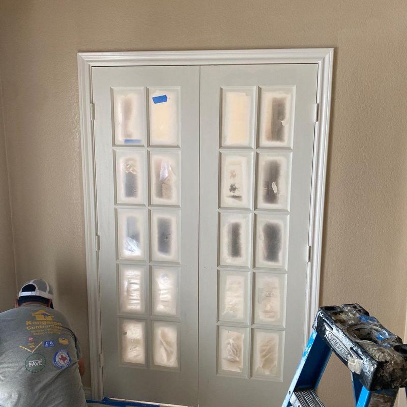 French doors installation in entryway with trim painting