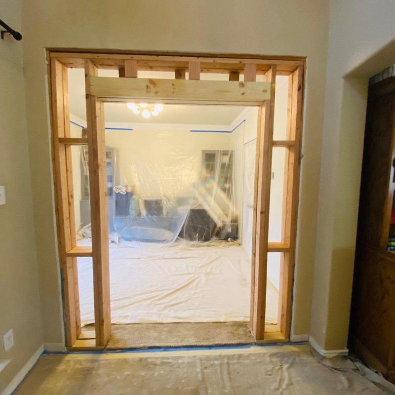 Doorway framing with new wood supports and protective coverings Doorway framing with new wood supports and protective coverings