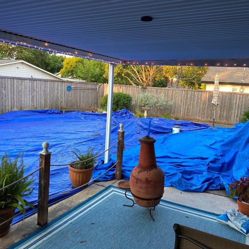 Swimming pool covered with blue protective tarps Swimming pool covered with blue protective tarps