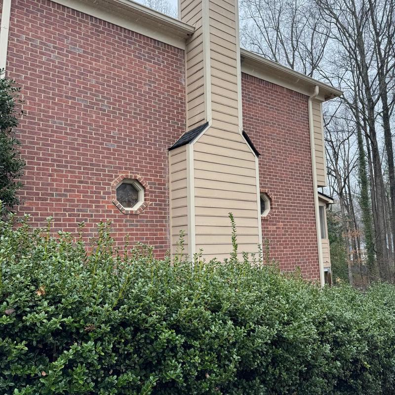 Chimney flashing and siding on brick house exterior