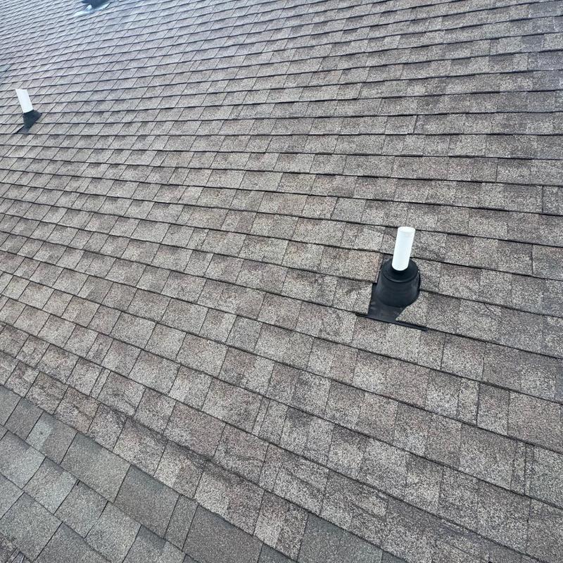 Asphalt shingle roof with vent pipe flashing inspection