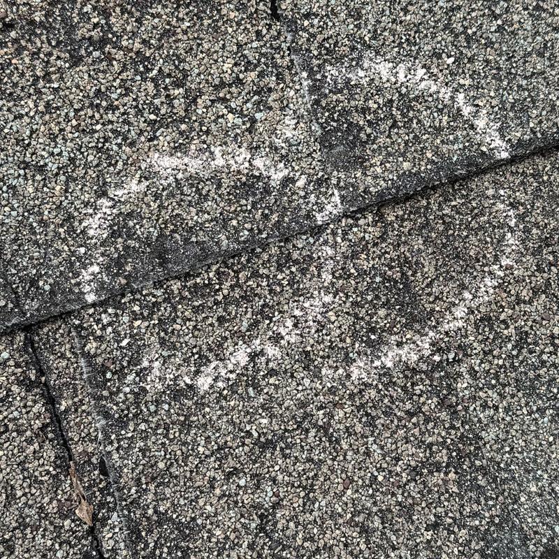 Asphalt shingle roofing with chalk damage markings