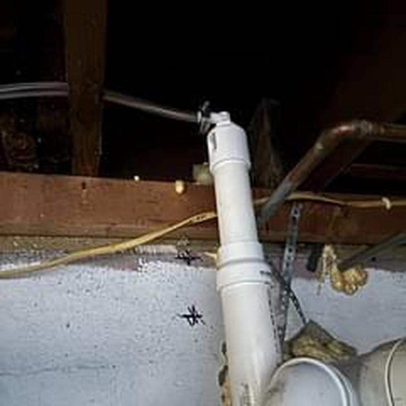 Water softener drain tubing with hose clamp installed