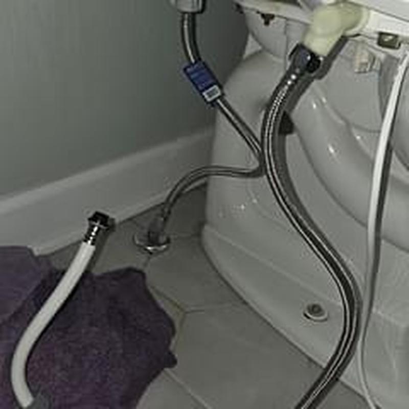 Bidet water line adjustment near toilet base