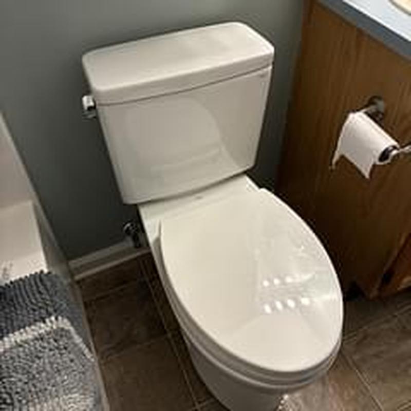 Toto ADA Drake toilet installed in bathroom corner