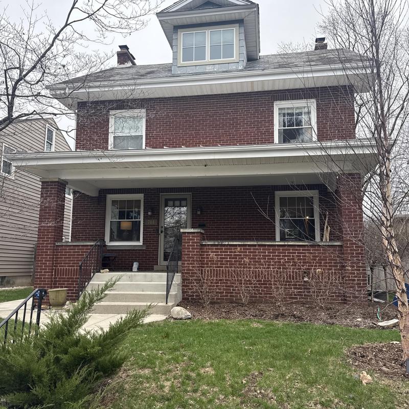 Brick residential home exterior with front porch and roof Brick residential home exterior with front porch and roof