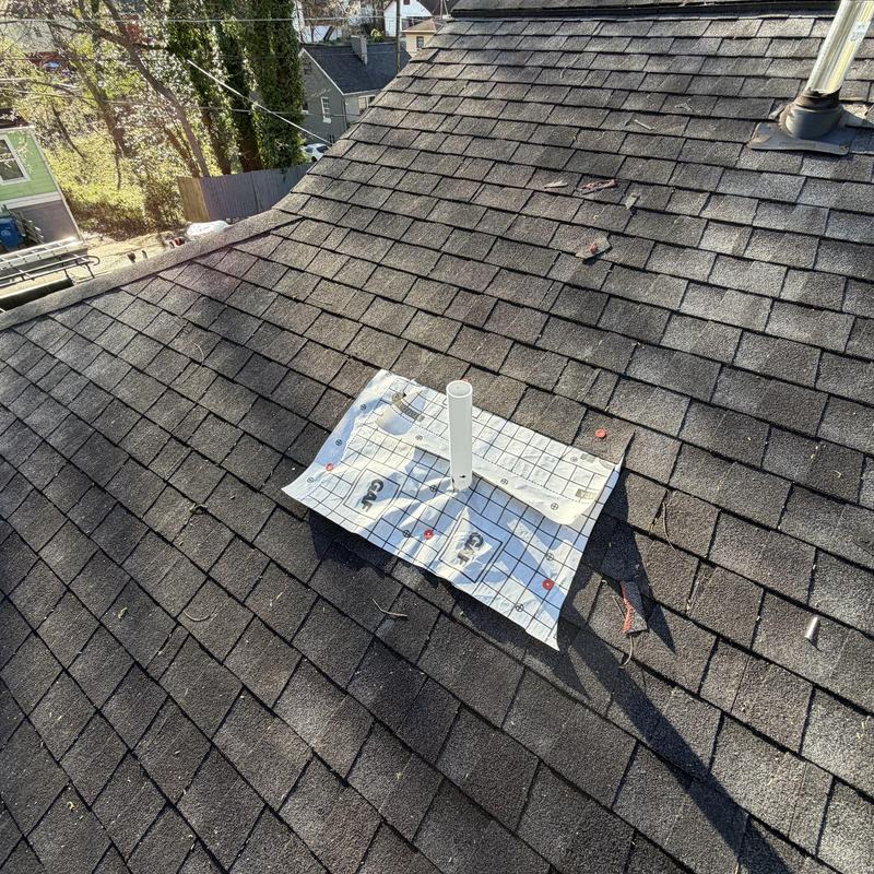 Missing pipe boot with temporary tarp on roof shingles
