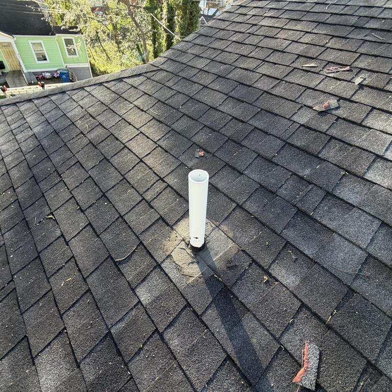 Roof pipe boot missing surrounded by damaged shingles