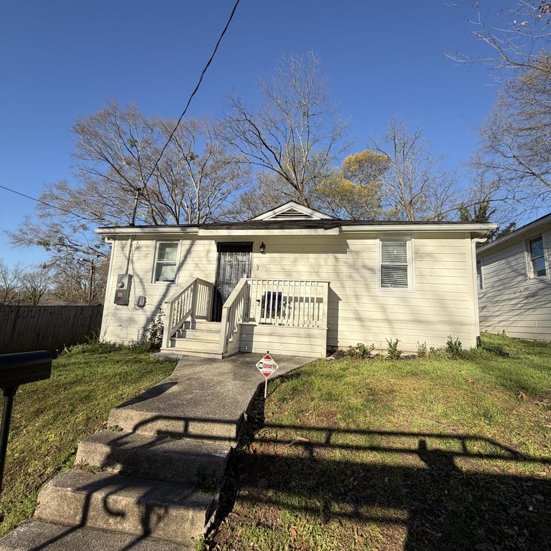 Charcoal asphalt roof with tarps on pipe boots