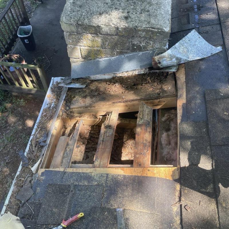 Chimney flashing and wood decking roof repair site