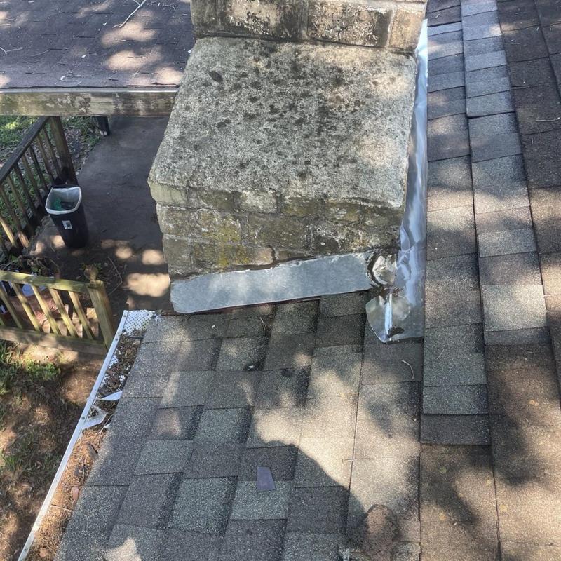Chimney flashing and shingle roof on residential home
