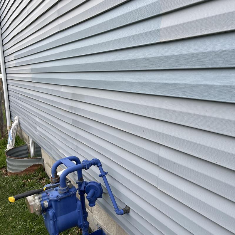 Vinyl siding panel distortion near gas meter setup Vinyl siding panel distortion near gas meter setup