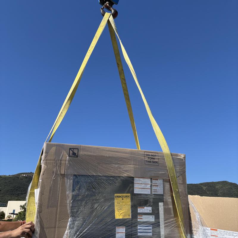 Goodman R32 3 ton package unit lifted by crane