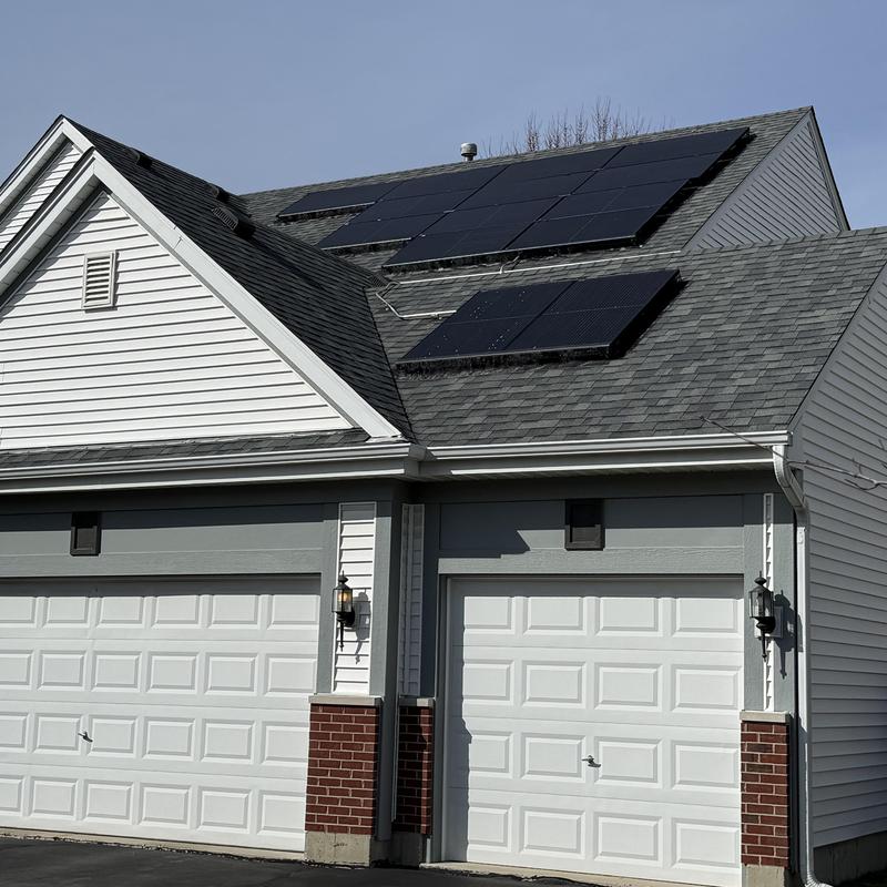 Solar panels on asphalt shingle roof with garages