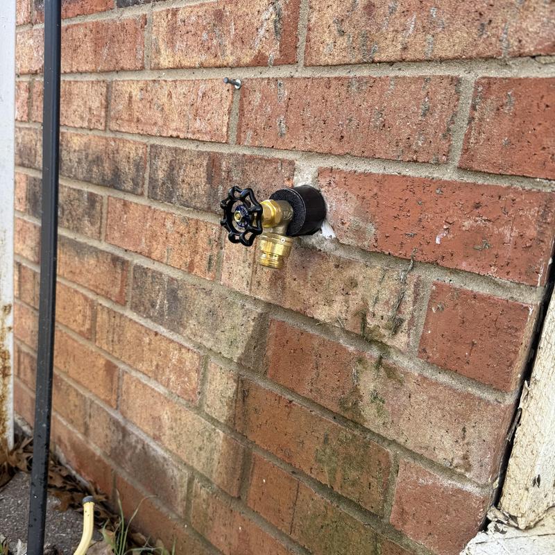 Hose bib valve on brick exterior wall installation