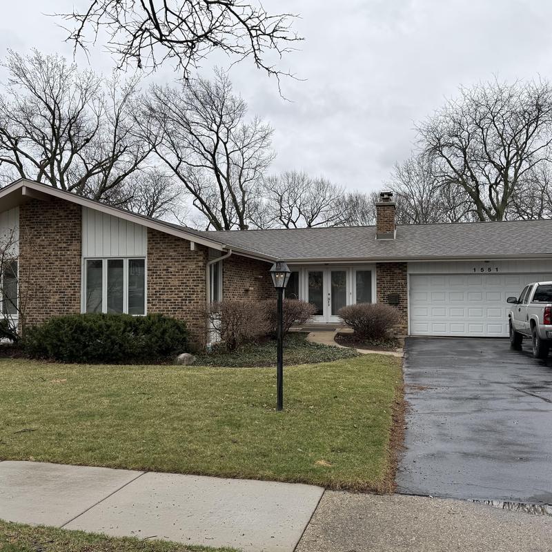 Gutters and gutter guards on brick house exterior