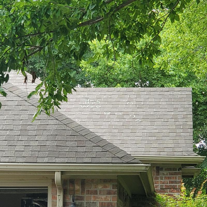 Asphalt shingle roof with chalk markings from hail inspection
