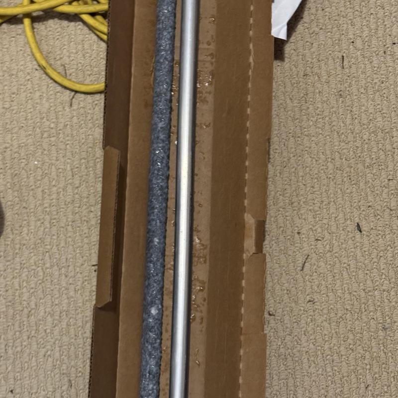 Water heater anode rods in packaging on carpet