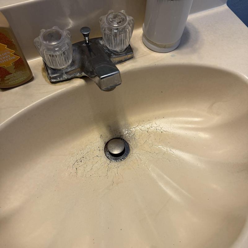 Bathroom sink drain with hair and grease buildup cracks Bathroom sink drain with hair and grease buildup cracks