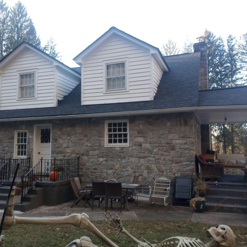 Asphalt shingle roof with dormers on stone home