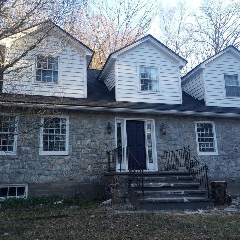 Stone exterior siding and front porch steps of home