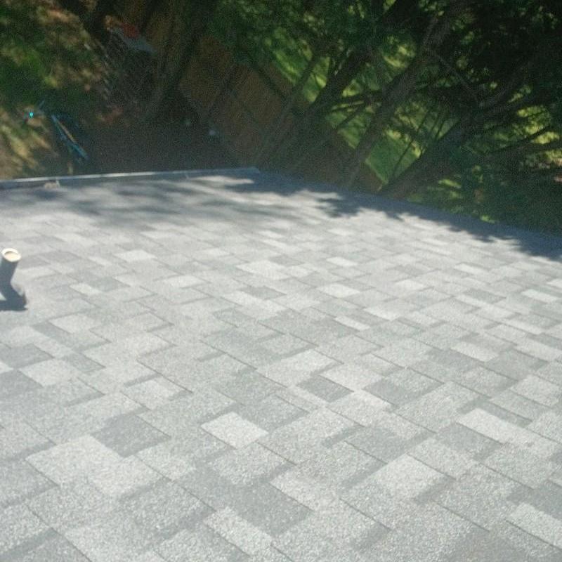 Pipe boot on shingle roof with fresh caulk sealant