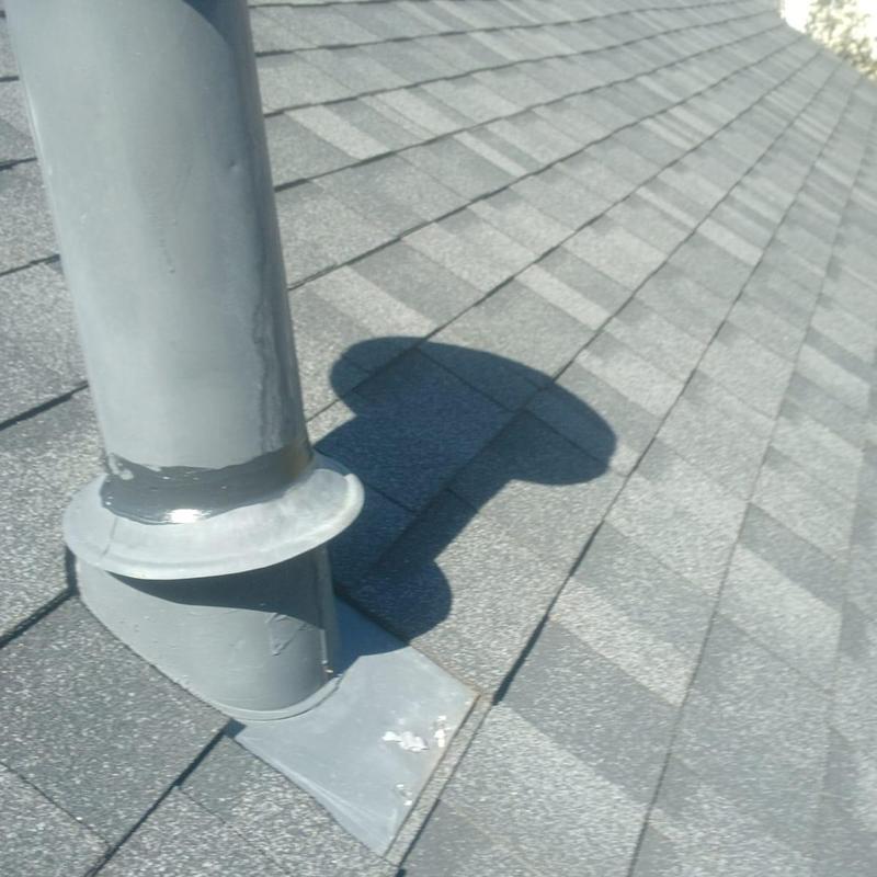 Pipe boot with new caulking on shingle roof