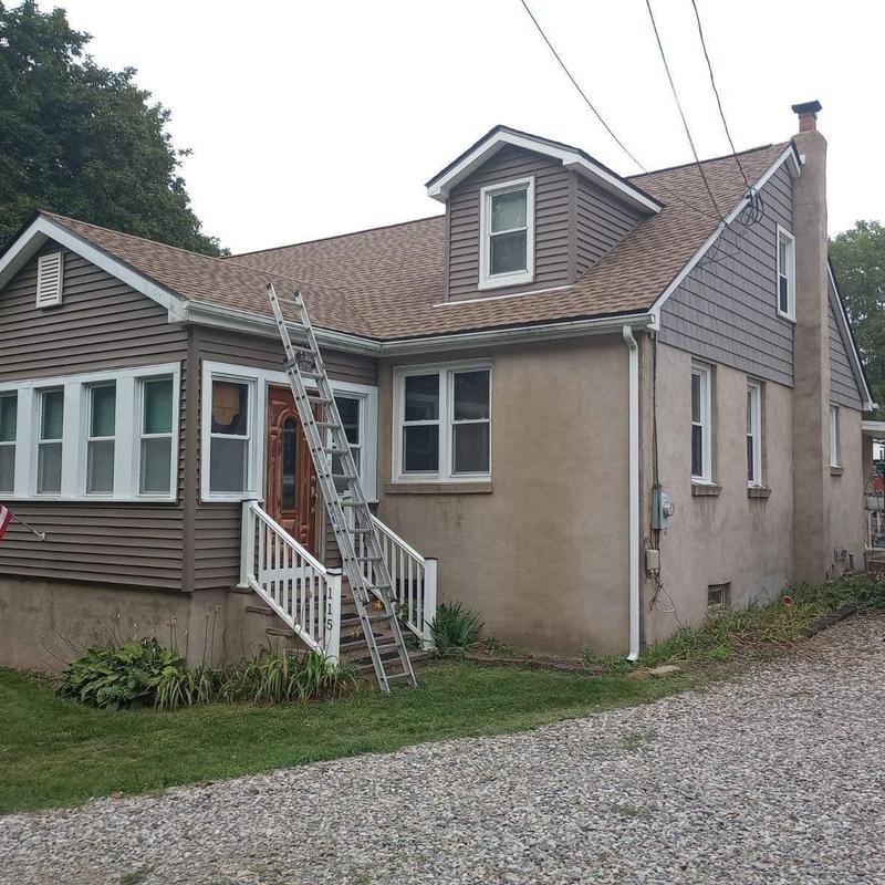 Asphalt shingle roof on residential home with ladder
