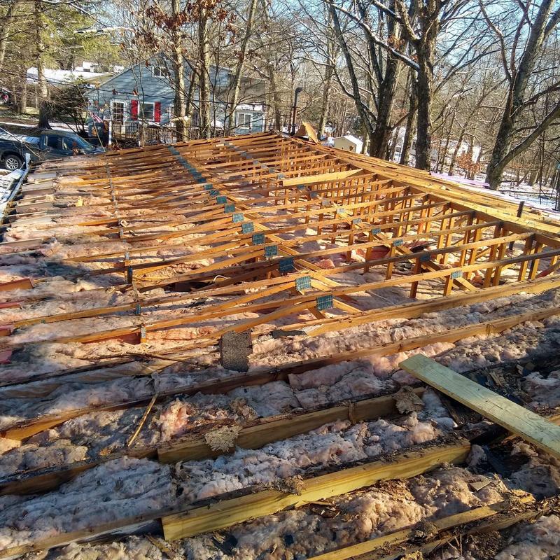Roof trusses and insulation exposed during replacement
