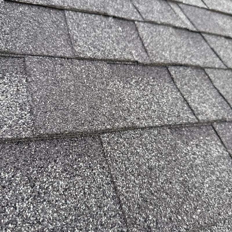 Asphalt shingles with hail damage and wear