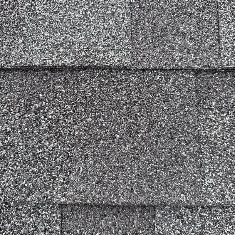 Asphalt roof shingles showing hail damage granules