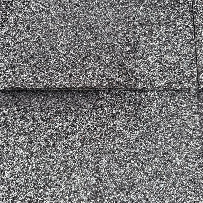 Asphalt shingles showing hail damage granules close-up