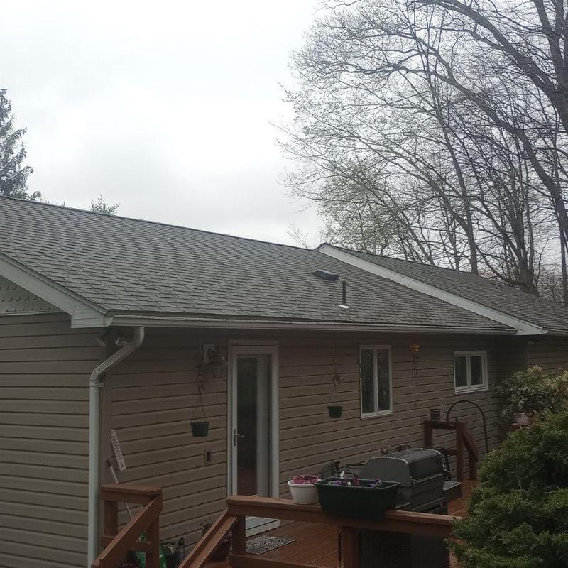 Asphalt shingle roof with new gutters on house