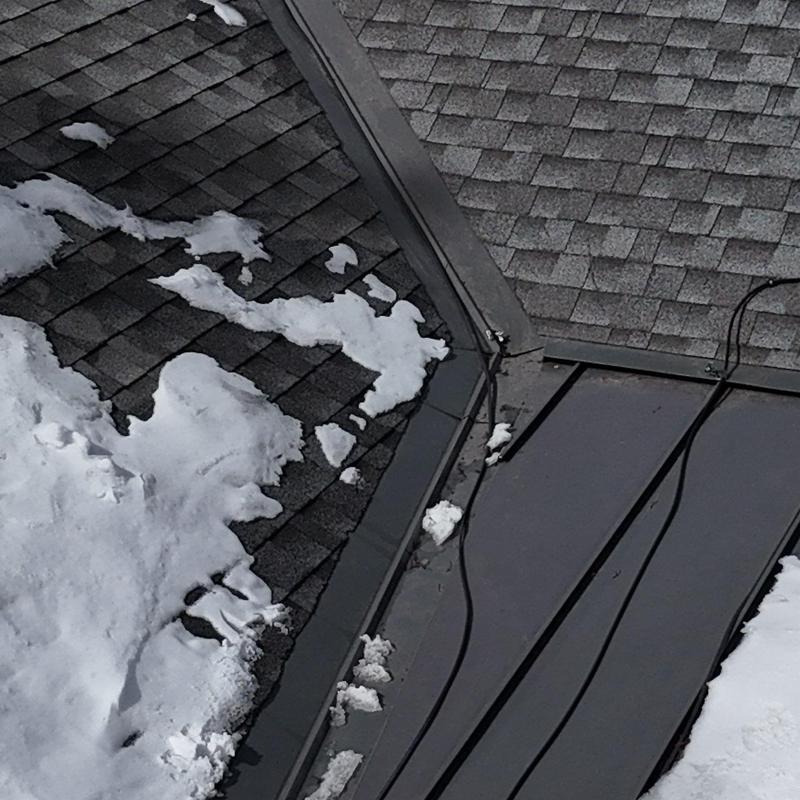 Metal roof section with heat tape and snow patches Metal roof section with heat tape and snow patches
