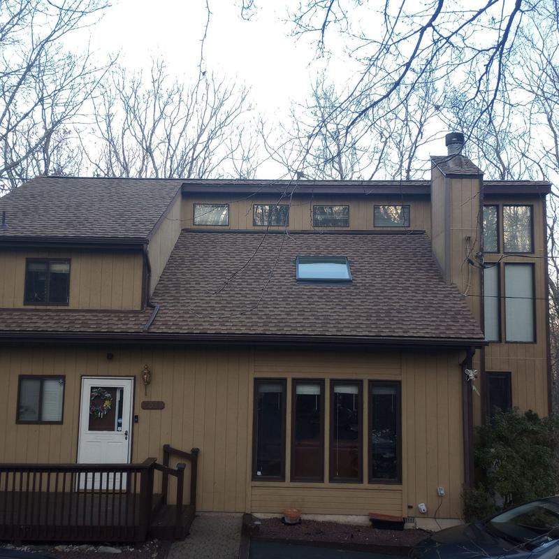 Asphalt shingle roof with skylight and chimney
