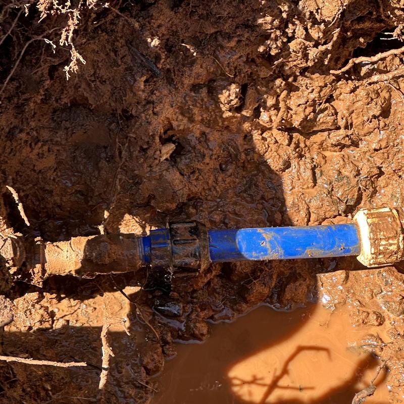 Main water line leak at meter repair in mud