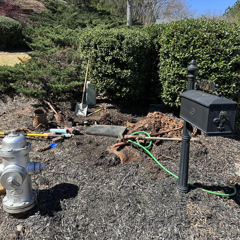 Main line water meter with leak repair tools and open ground