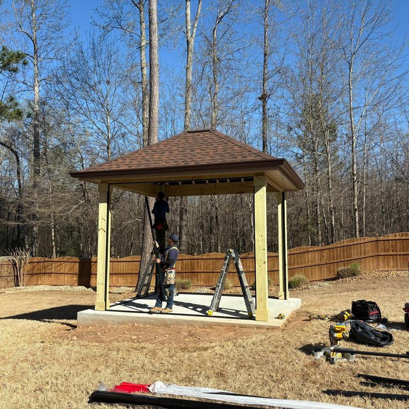 Gazebo gutter installation with workers and tools