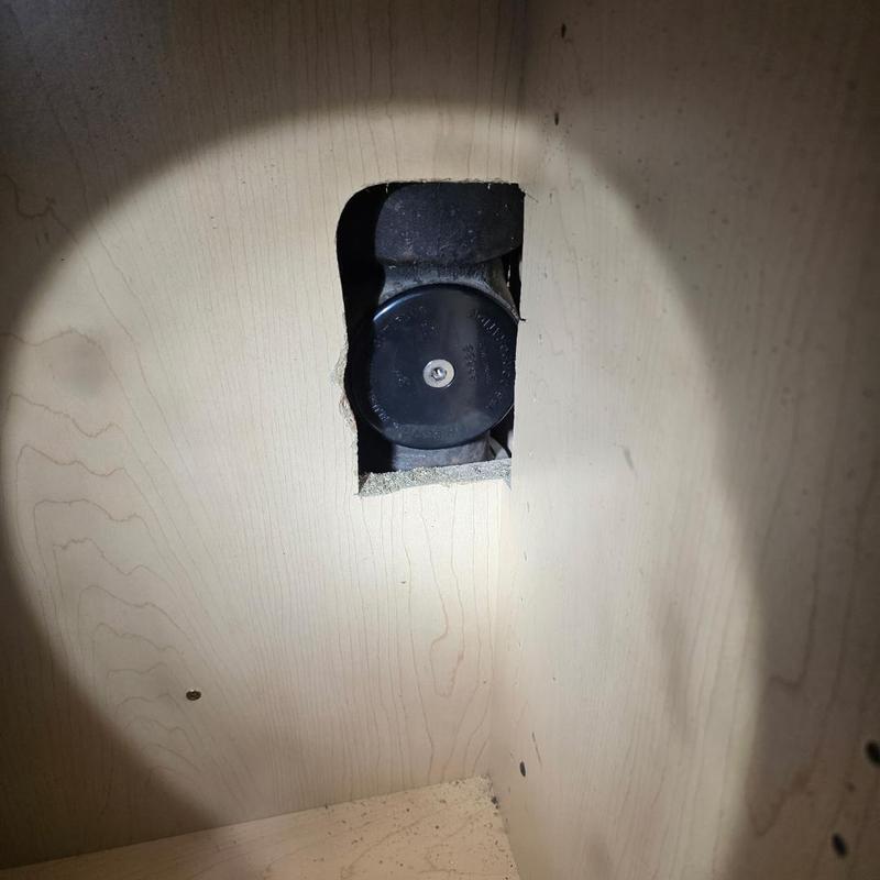 Brass cleanout plug in wall cavity with pipe access