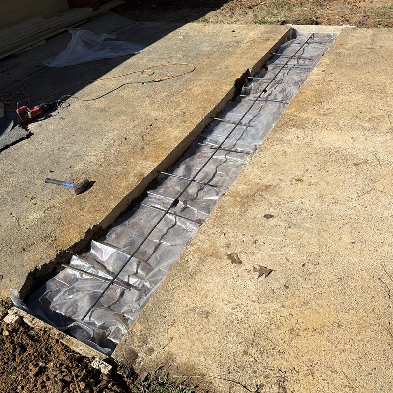 Concrete driveway with rebar and plastic sheeting prep