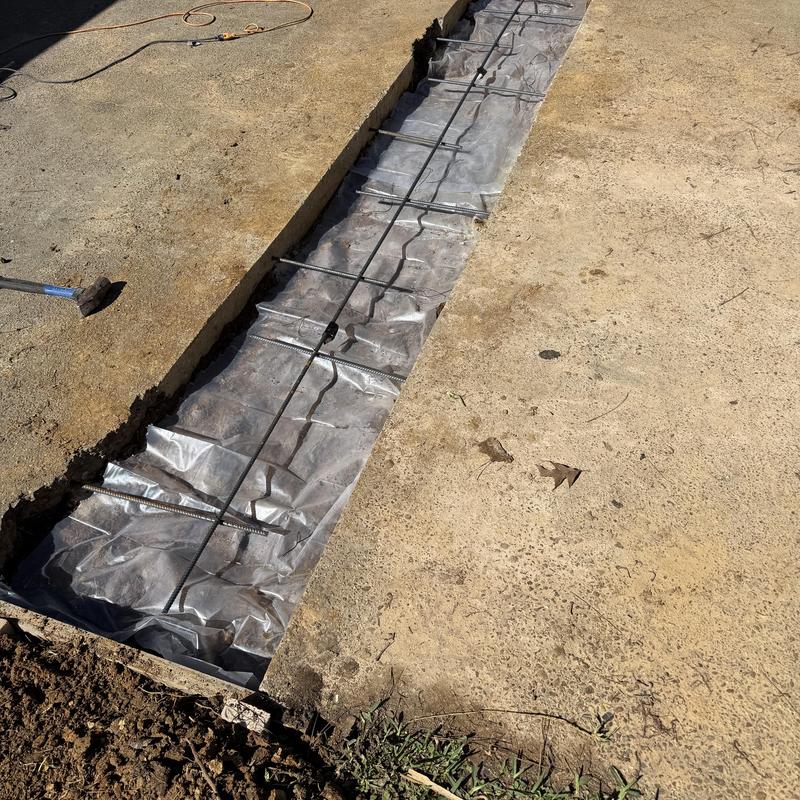 Concrete driveway with rebar and vapor barrier installation