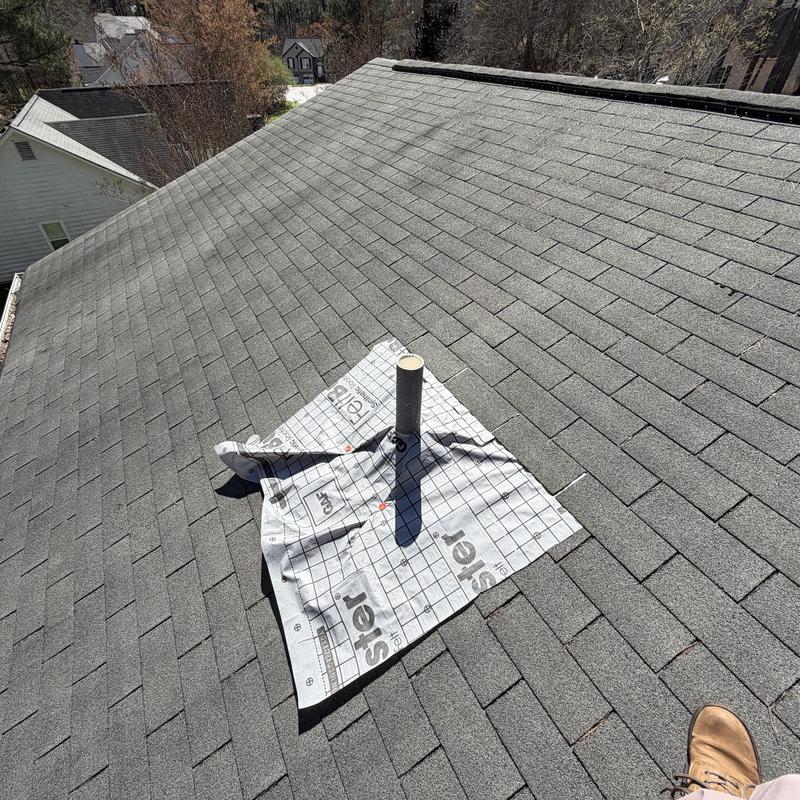 Pipe boot with temporary tarp on roof decking