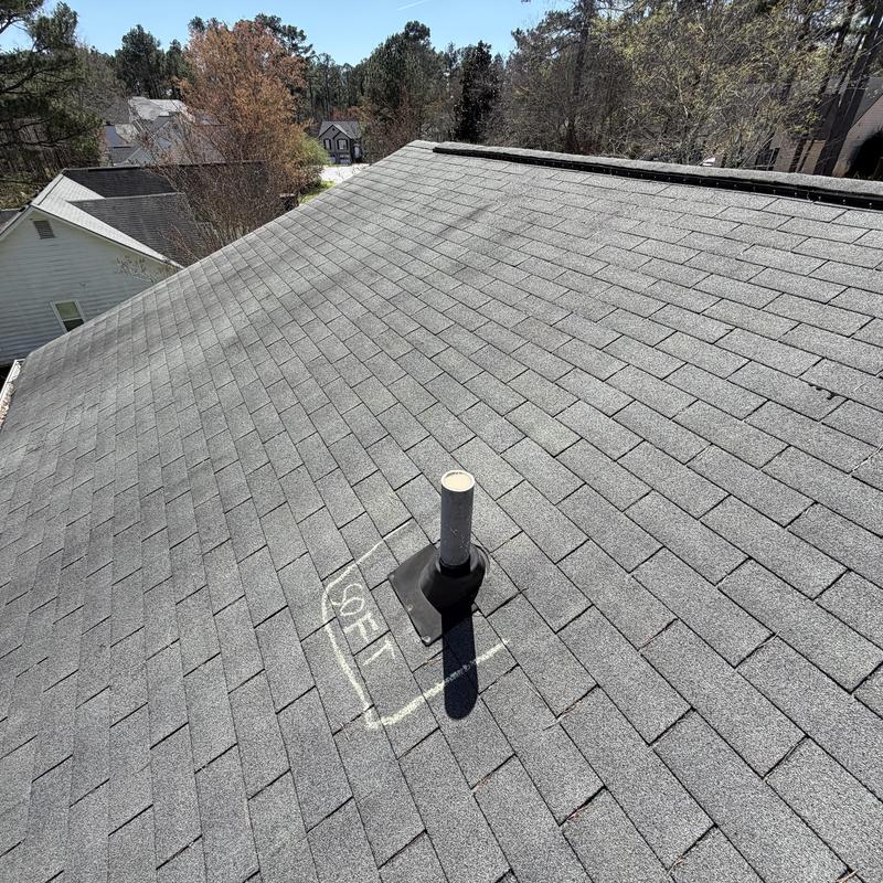 Pipe boot on faded slate asphalt shingle roof