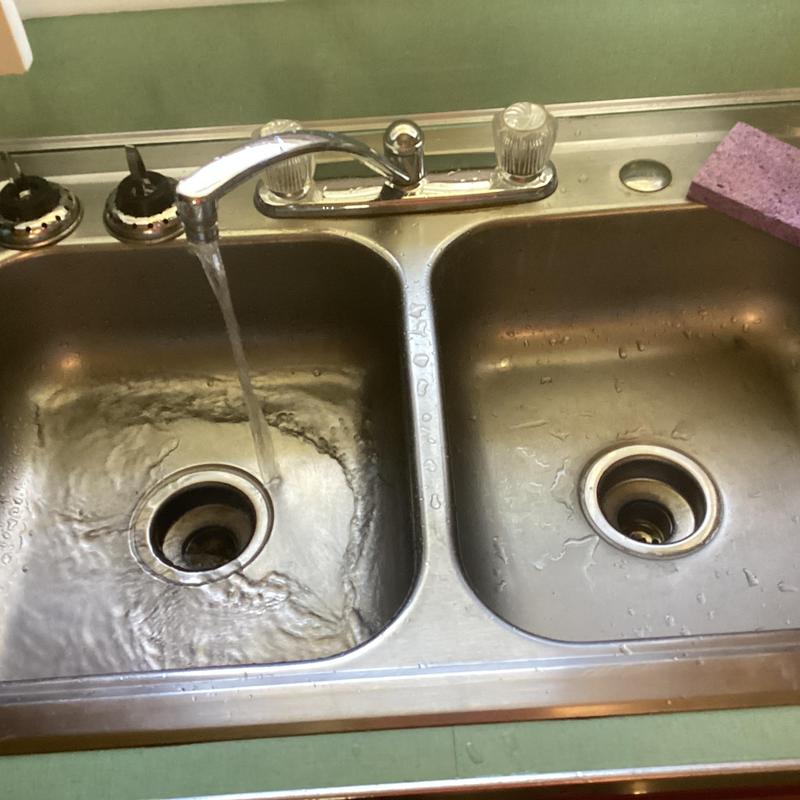 Kitchen sink drains with running water flow