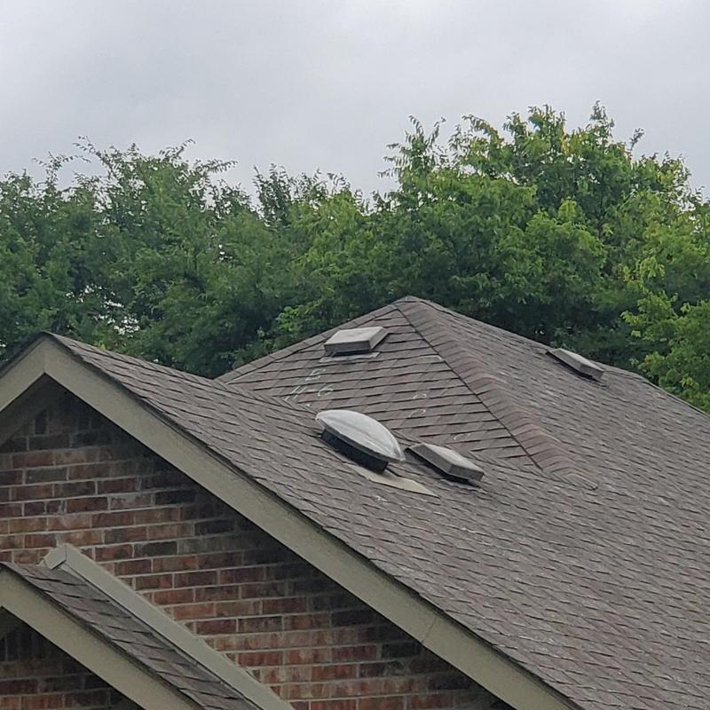 Roof shingles with wind and hail damage near vents